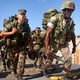 U.S. soldiers board a troop-transport boat near the West Nile city of Alexandria.